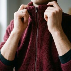 Close-up of burgundy fleece jacket collar showing dense pile texture